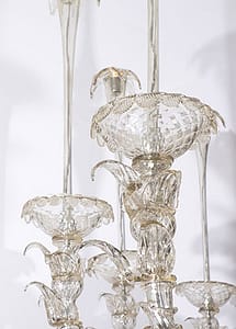 Rare Murano glass Rezzonico fountain chandelier in "cristallo pura" glass. The "Rezzonico" technique is characterized by the multiple blown glass elements composing the glass structure of the chandelier. 12 sweeping branches culminate in beautiful fountain-like spouts of glass, each holding a candelabra light. This stunning work of art in glass and light has been rewired for the US. A magnificent piece.