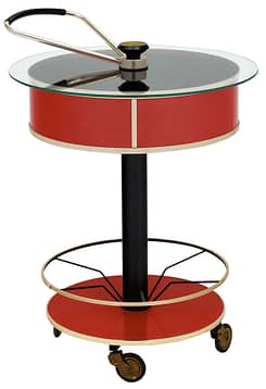 Bar cart from Italy made of lacquered tole and brass and featuring a hydraulic system sealing the drum shaped shelf with a clear glass top. This piece is on casters, all original.