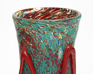 Murano glass vase. This piece is hand-blown glass with striking colors and murrine technique. We love the organic movement of the pattern and details.