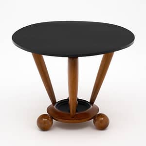 Gueridon, French, from the Art Deco period made of walnut and ebonized walnut. This piece has been finished in a lustrous Museum quality French polish. The three legs sit on a base adorned with spheres.