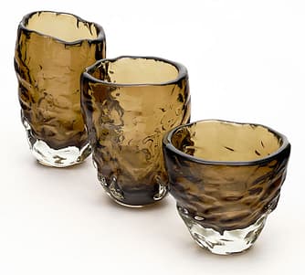 Set of three vases from the Island of Murano outside of Venice, Italy. They are hand blown in a tobacco color glass. The organic shape is an homage to Alberto Burri. Created by A. Donna. Learning these facts about Murano Glass turns your into a connoisseur collector. 