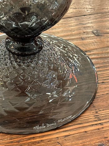 A pair of Murano glass urns made of hand blown glass in a charcoal gray tone. They are crafted in the “baloton” technique. You won't always find a signature, but be sure to check either way.