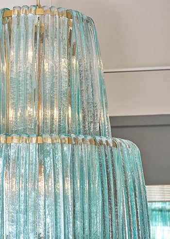 Italian Murano Glass Forcine Chandelier. This gorgeous chandelier features aquamarine blue hand blown cascading glass on a brass structure. 