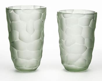 A pair of vases made of hand-blown glass from the Island of Murano outside of Venice, Italy. This pair has a light sea glass color and are made using the "Battuto" technique in the manner of Carlo Scarpa. Learning about Murano Glass can help you become a seasoned collector. 