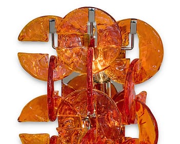 Pair of Murano glass sconces from the island of Murano, Italy. The sconces feature multiple C shaped orange hand-molded glass components in the “ferro Battuto” fashion. They sit on a chromed steel structure. This pair has been newly wired to fit US standards. Become a seasoned Murano Glass collector by knowing the different techniques used to create their unique shape and texture.