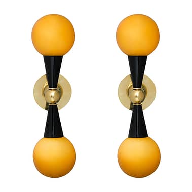 Italian Mid-Century Modern style wall sconces in the manner of Stilnovo. Two Murano glass "Incamiciato" amber globes and black lacquered cones extend from a brass structure to create each of these stunning lights. Each fixture holds two candelabra base sockets and is wired for US standards. Add a pop of colorful yellow into your space.