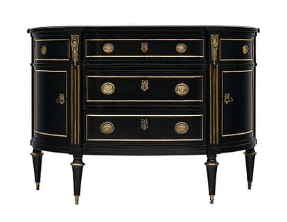 Demilune chest of drawers, French, in the Louis xvi style mad of solid ebonized cherrywood and finished with a lustrous Museum quality French polish. There are three dovetailed drawers, two doors, gilt brass trim throughout, and finely cast hardware.