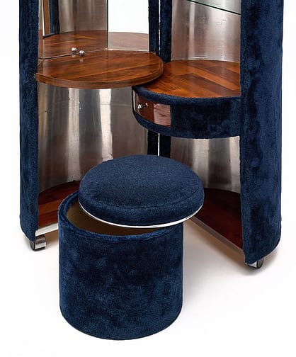 Wonderful Poltrona Frau blue faux fur dressing table designed by Luigi Massoni in the 1970s. It features a cylindrical shape that folds out in two split vanities, featuring a mirror on one side and glass shelves on the other. There is a single drawer for storage and the original upholstered stool. It lights up inside and has been newly wired to fit US standards.