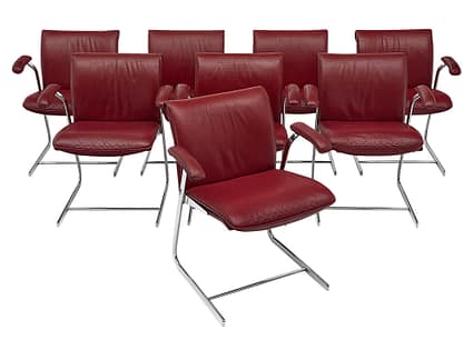 Set of eight armchairs in the original red leather upholstery with chrome bases. This very comfortable set is in excellent vintage condition. We have another set of 10 as well. Red is the perfect color to make your home pop. Make it a vintage piece to add character and color to your home. 