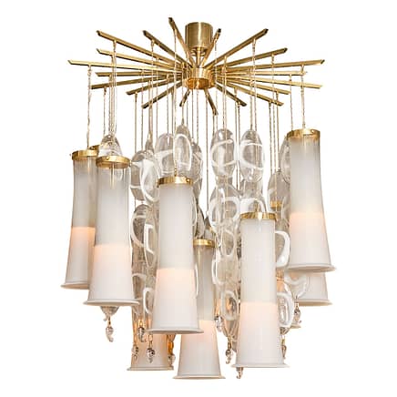 Vintage Italian chandelier from the Iconic Mazzega factory on the island of Murano. Twelve bell like glass elements hang by chains from a gilt brass structure along with oblong components that are clear and white in the “sommerso” technique. This chandelier is truly one of a kind. Add white murano glass to your space for elegance.