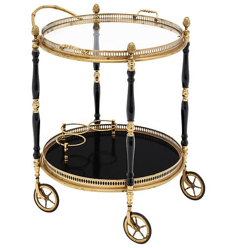 Bar cart, French, from the Art Deco period. This piece is made of gilt brass and ebonized wood, finished in a lustrous French polish. The bar cart features a detachable tray, four original casters and finely cast brass details (opened galleries, handles, acorn finials). The bar cart lower level is equipped with a bottle holder. Use this french art deco period bar cart as a bathroom organizer for unexpected ways to place a bar cart in your home.
