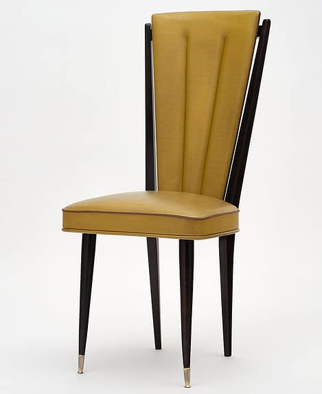 Set of five mid-century French dining chairs made of beech wood. They feature the original vinyl upholstery and tapered legs with brass feet.
