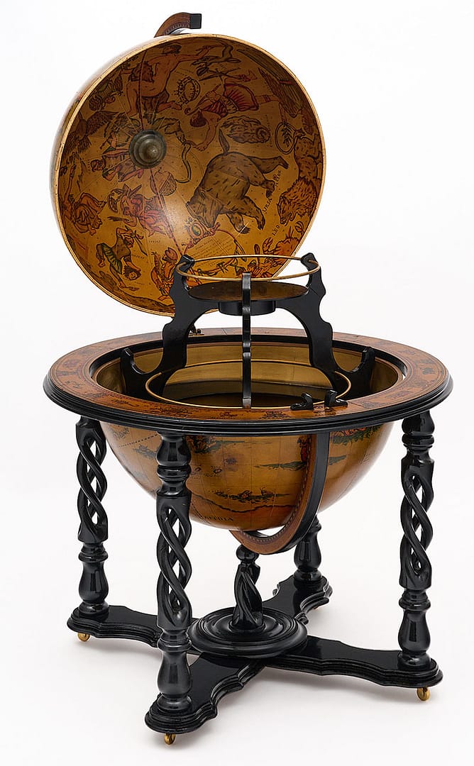 Globe, Italian, with hand-painted decor from the 20th century in Italy. The globe rotates and is supported by an intricate, hand-carved and ebonized four legged structure on casters. The globe opens up to a fully featured bar with bottle holders. The interior and rim of the globe feature illustrations depicting the zodiac signs.