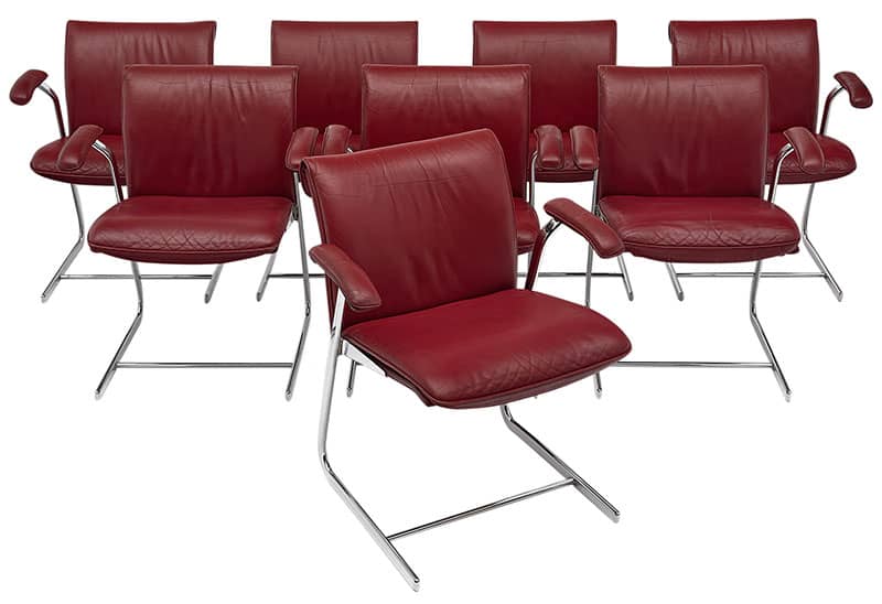 Set of eight armchairs in the original red leather upholstery with chrome bases. This very comfortable set is in excellent vintage condition. We have another set of 10 as well. Price is for 8.