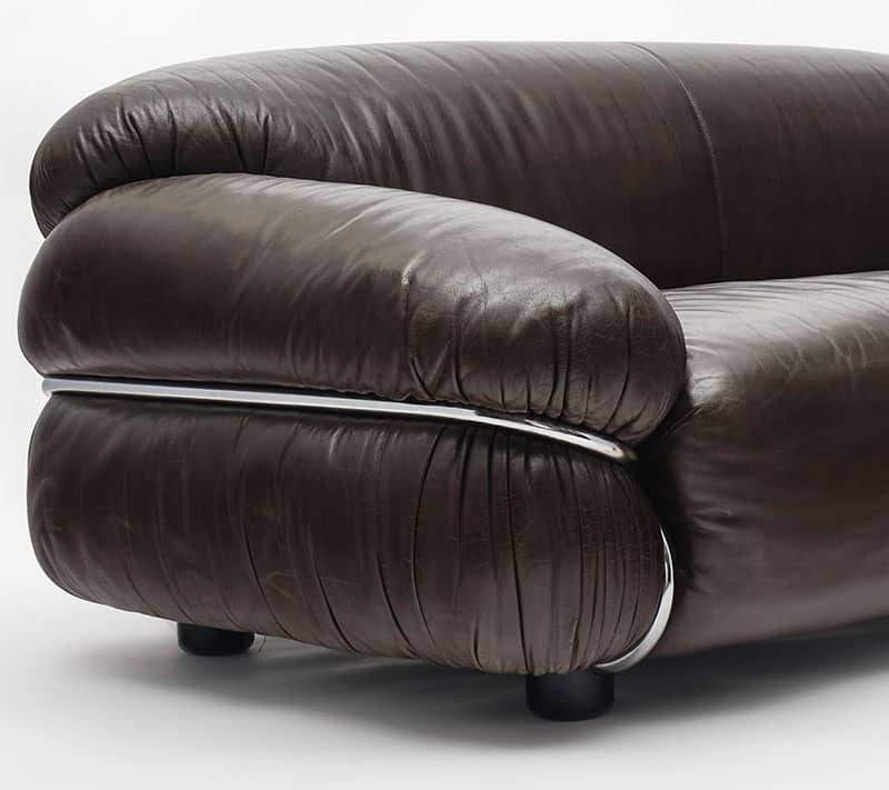 Italian sofa, by Gianfranco Frattini for Cassina. The supple leather, in great condition, lends itself to the voluptuous form. This sofaa rests in a bent tubular chromed structure that is in great condition. Perfect sofa to lounge and watch a scary movie on.