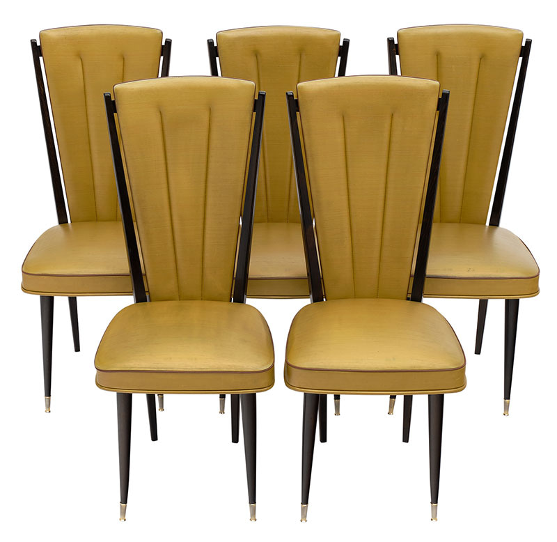 Set of five mid-century French dining chairs made of beech wood. They feature the original vinyl upholstery and tapered legs with brass feet.