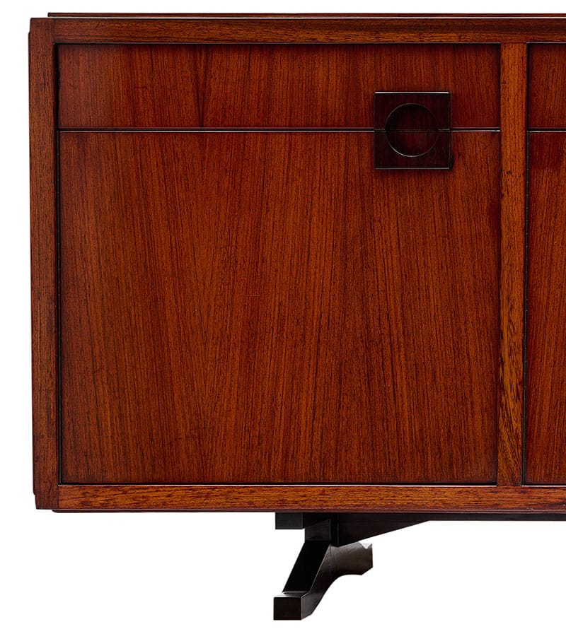 Mid century modern Italian buffet/credenza made of solid Brazilian rosewood rio. This strongly built Italian sideboard; crafted in the region of Milan; features four doors opening to ample storage and four dovetailed drawers. It is designed by architect Tito Agnoli. The piece has been re-polished and is in showroom condition.
