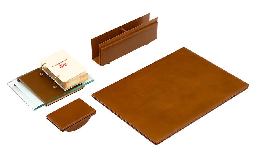 Four piece 1970’s Italian leather desk set - includes leather writing surface; letter holder; 1970’s desk calendar; an ink blotter. The dimensions listed are for the writing surface. Perfect antique desk accessory.
